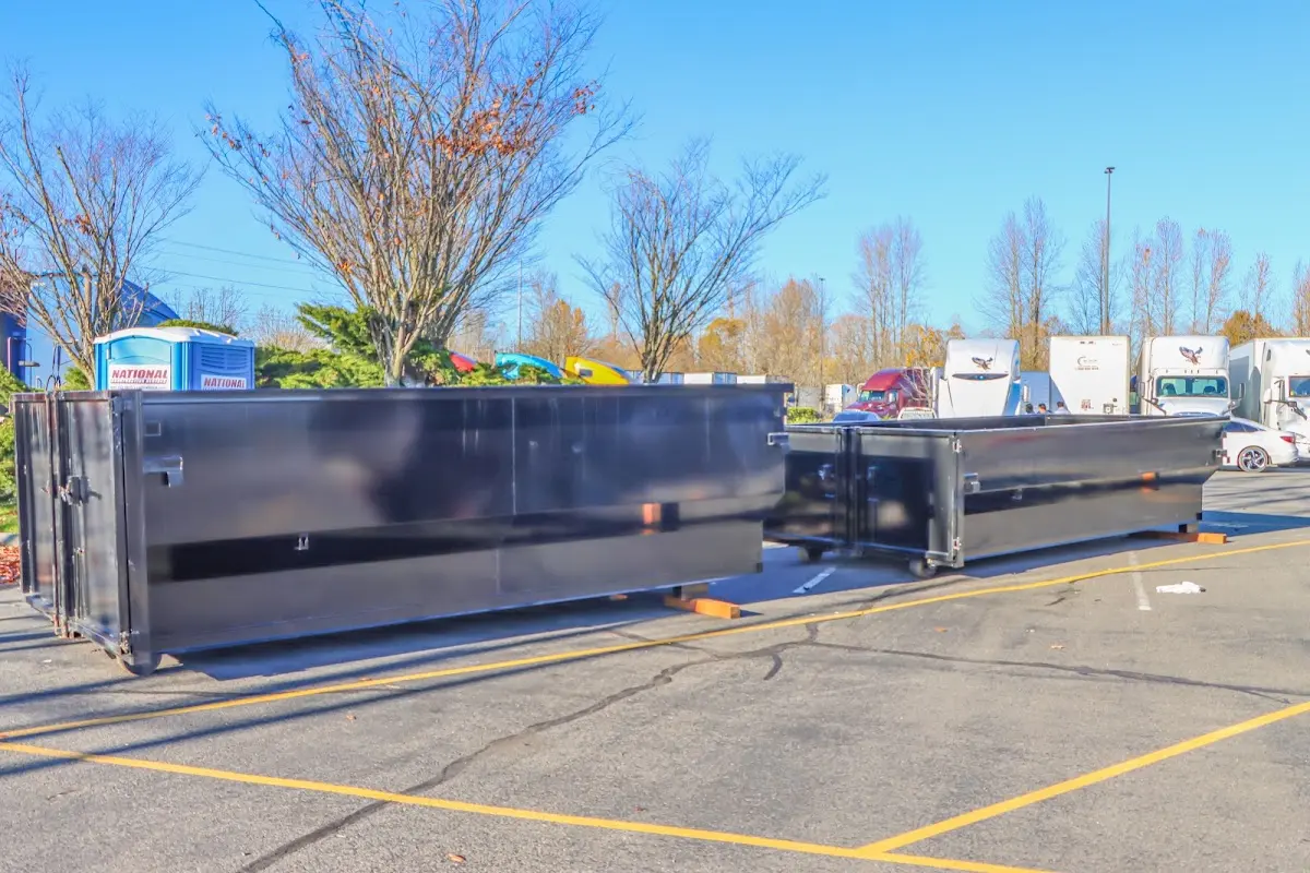 Professional dumpster rental service with roll-off container on residential driveway in White Plains